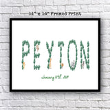 A framed print with the name "Peyton" made up of various animal and leaf shapes, including a giraffe, lion, and elephant, against a white brick wall background.
