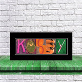 A framed collage of various sports-related images, including baseball gloves, baseballs, and a baseball bat, arranged to spell out the name "KOSSEY".