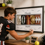 A young man in a football jersey is writing on a framed collage of football-related images, including helmets, footballs, and other football-related items.