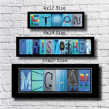 three framed artworks, each with a different size and design, arranged on a white brick wall.