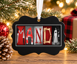 a black ornament with the word "MAND" spelled out in a decorative manner, surrounded by holiday decorations such as a Christmas tree and ornaments.