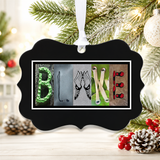 A black ornament with the name "BLAKE" spelled out in a creative and artistic manner, using various objects such as pine cones, berries, and other natural elements.