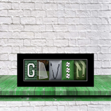 A framed collage of various sports-related images, including soccer balls, a soccer net, and a pair of soccer cleats, arranged to spell out the word "GIVE".