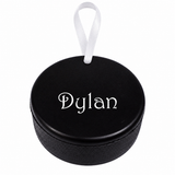 Personalized Dylan hockey puck metal ornament with white ribbon on white