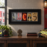 Personalized firefighter letter art in a black frame displayed in a fire station office