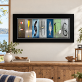 Fishing photographic letter art in a black frame displayed above a wood console in a lake house