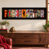 Firefighter photographic letter art in a black frame above a walnut console in a home study