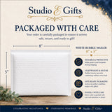 Studio E Gifts packaged with care in an 8 by 5 inch white bubble mailer
