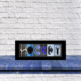 A framed collage of various images, including a hockey stick, a hockey player, and a hockey rink, arranged to spell out the word "HOCKEY".