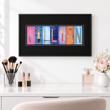 A framed collage of colorful letters spelling out "WILLIAM" is displayed on a white wall above a vanity with makeup brushes and a perfume bottle.