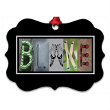 A black frame with the word "BLAKKE" spelled out in a creative and artistic manner using various objects such as a necklace, a pair of hands, and other items.