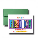 A green envelope with a colorful greeting card inside, featuring the text "HAPPY FIRST DAY of PRESCHOOL" and a pencil.