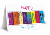 A birthday card with the word "BIRTHDAY" spelled out using colorful blocks, with the name "Mrs Smith" written below.