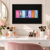 A framed artwork with the name "VILLAN" displayed in colorful letters is hanging on a wall above a vanity with makeup and beauty products.